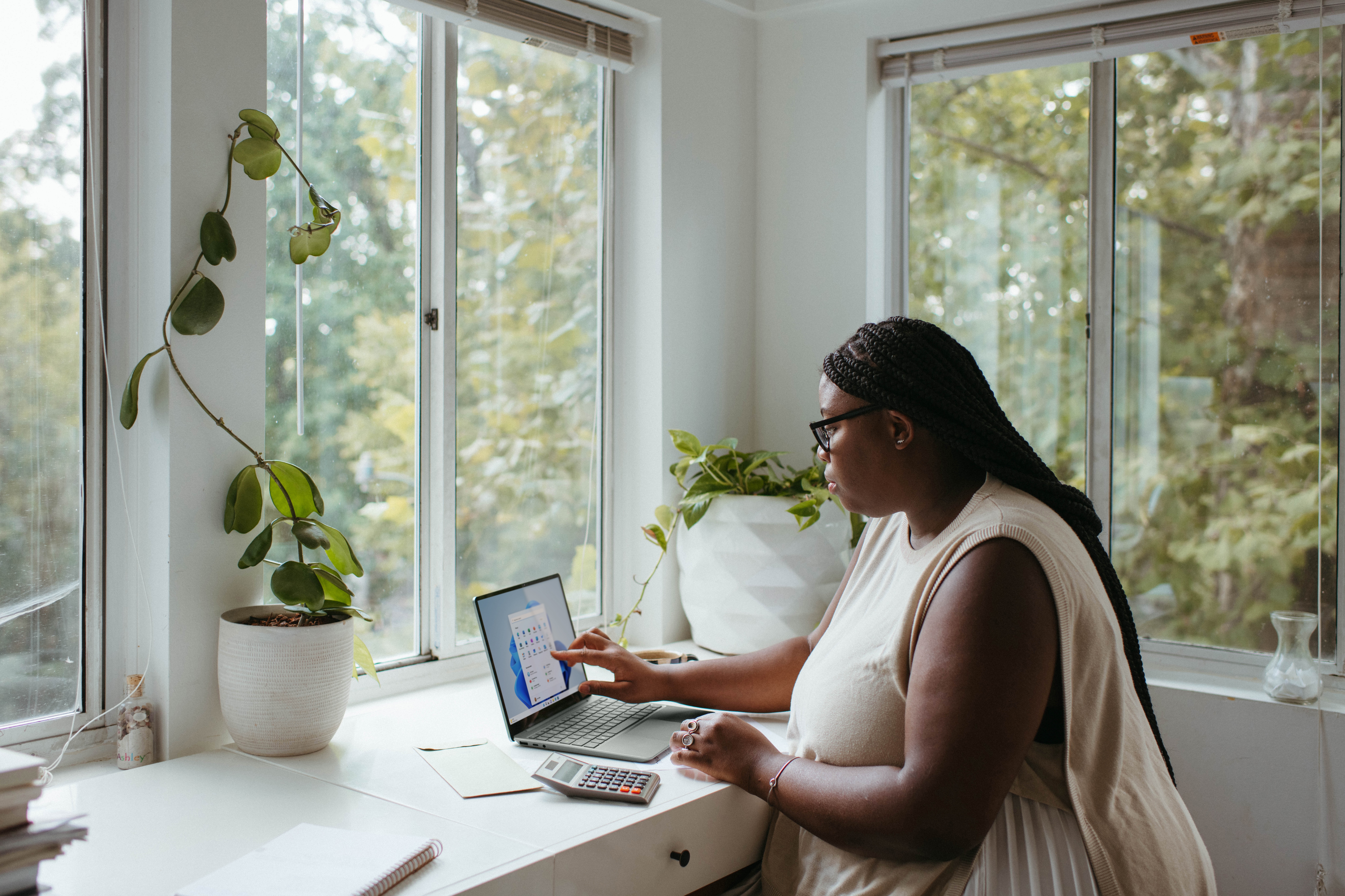 woman working on laptop and looking at charts