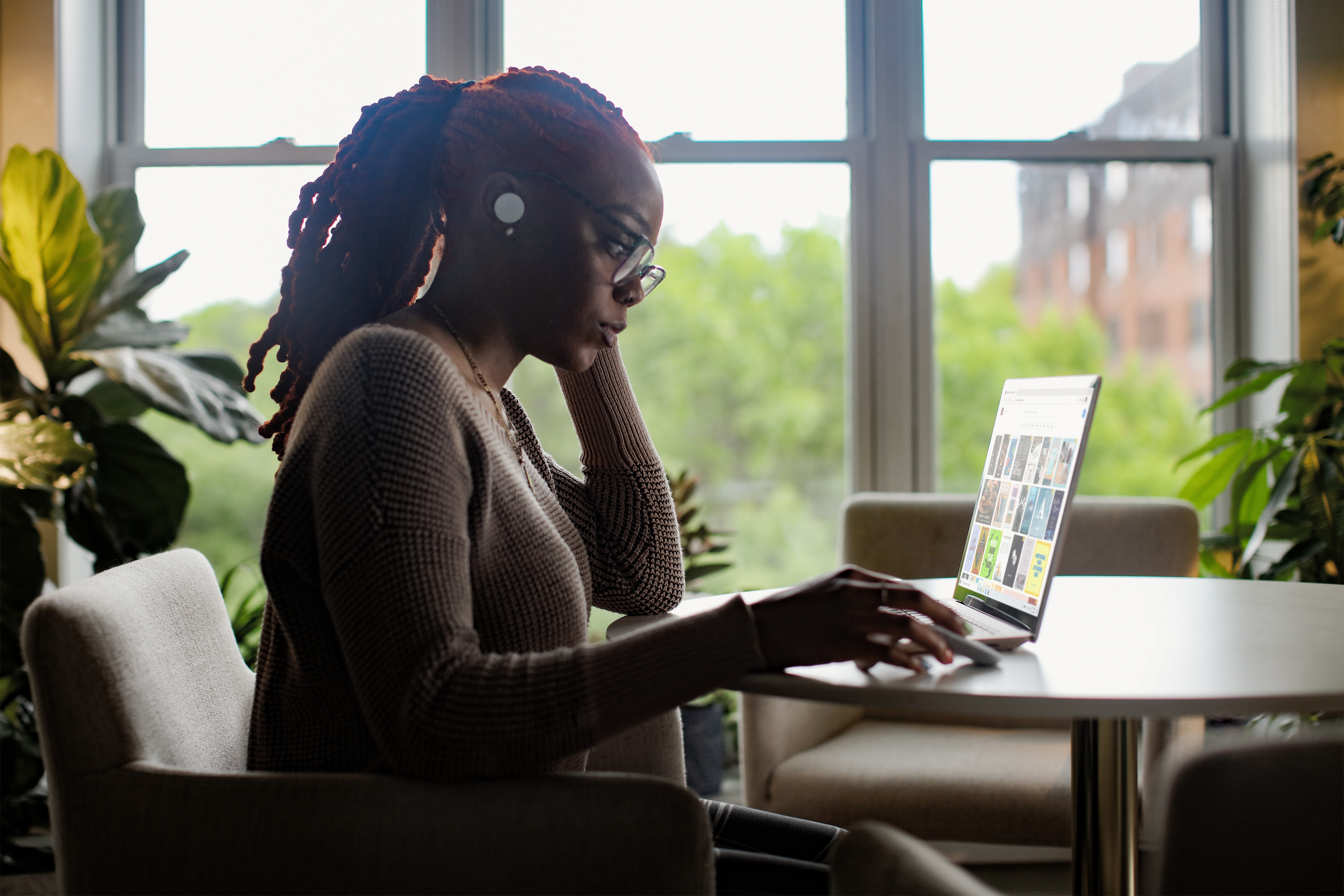 woman working on laptop and looking at charts